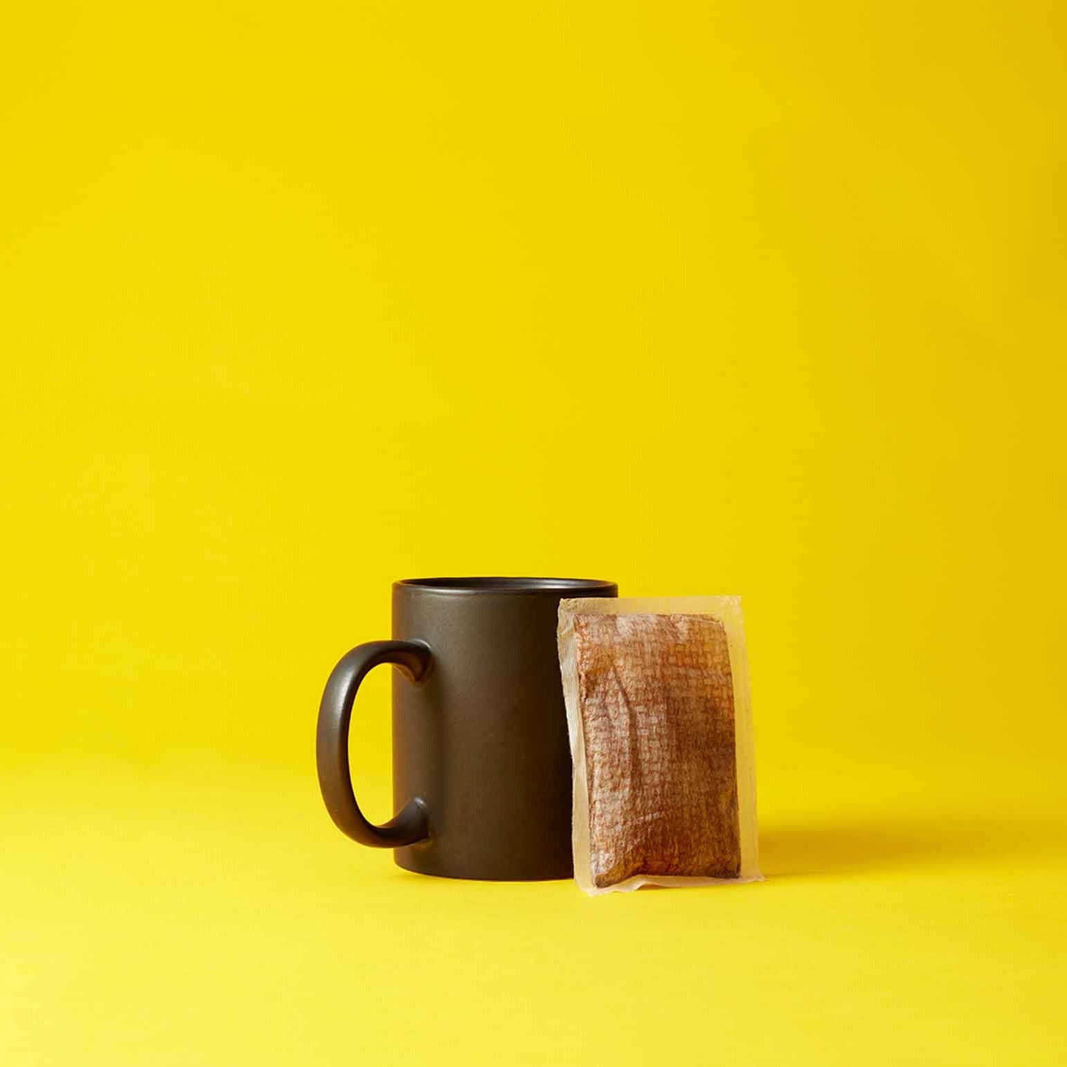 Black mug and coffee bag